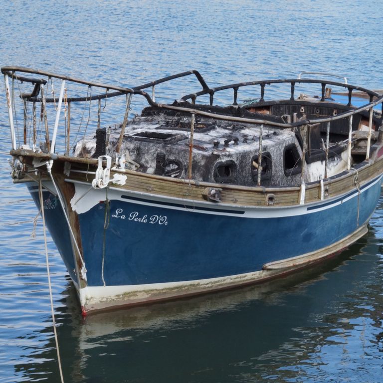 Half burned abandoned boat